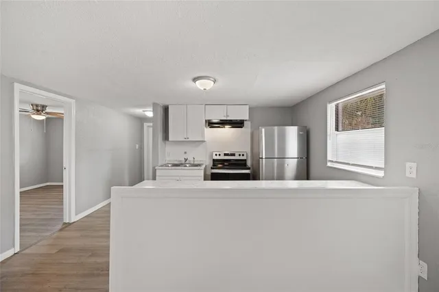 a kitchen with stainless steel appliances a refrigerator and a stove top oven