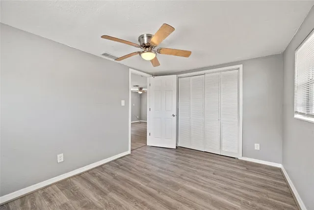a view of room with hardwood floor and window