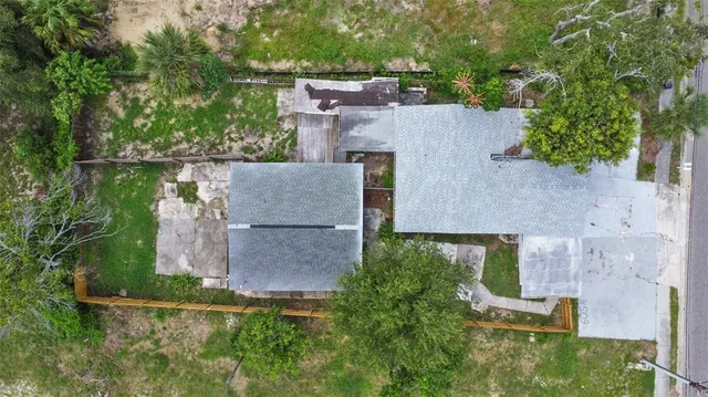an aerial view of a house with a yard and lake view