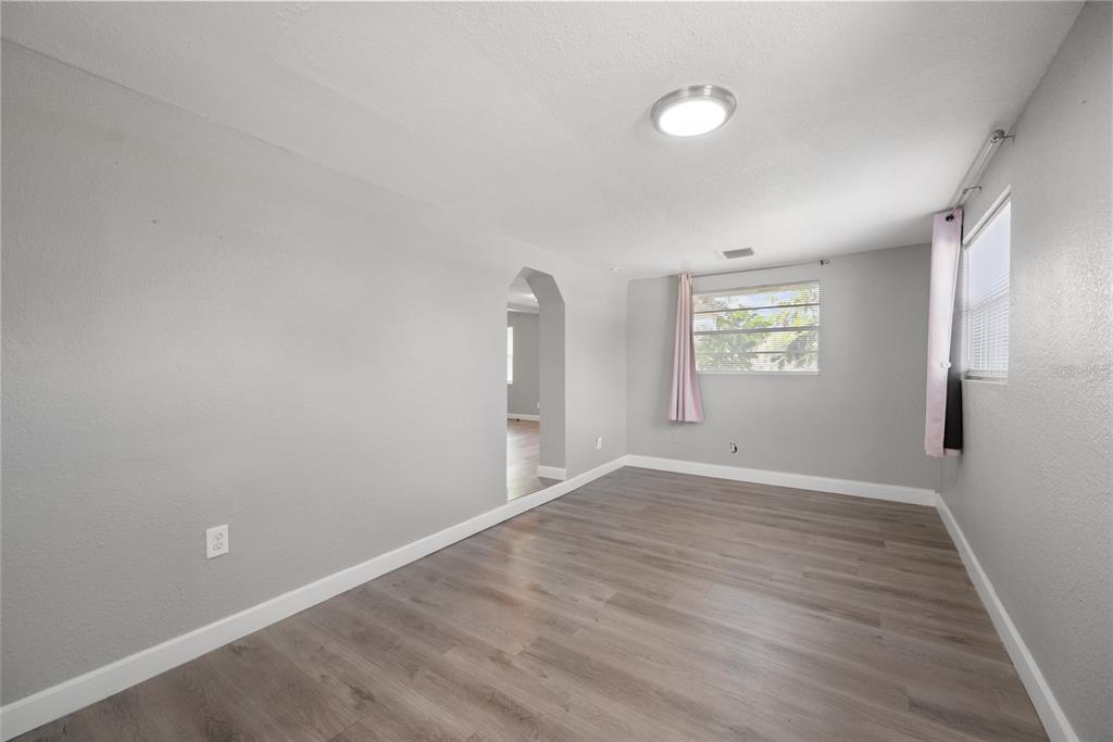 605 South Disston Avenue Tarpon Springs, FL 34689 - Photo 6 of 47 wooden floor in an empty room with a window