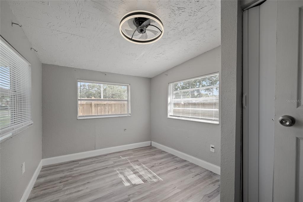 605 South Disston Avenue Tarpon Springs, FL 34689 - Photo 8 of 47 a view of an empty room with window and wooden floor