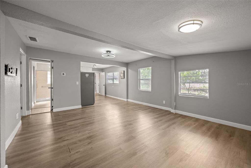 605 South Disston Avenue Tarpon Springs, FL 34689 - Photo 10 of 47 an empty room with wooden floor and windows
