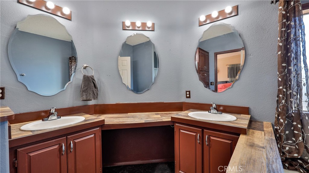 39550 Kirby Road Anza, CA 92539 - Photo 26 of 53 a bathroom with a double vanity sink and a mirror