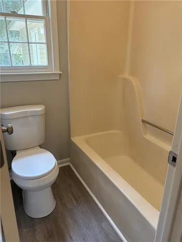a bathroom with a toilet and a bathtub