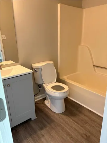 a white toilet sitting next to a bathroom sink