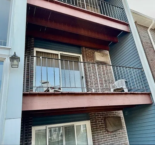 a wooden bench sitting in front of a house