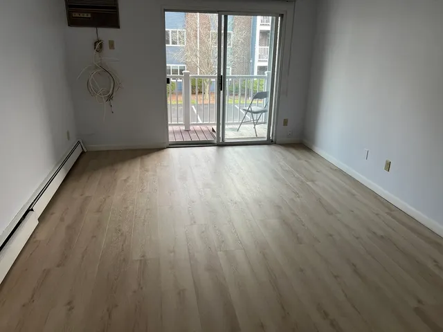 a view of room with wooden floor and fan