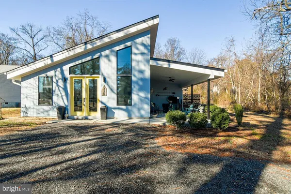 a view of a house with backyard porch and sitting area