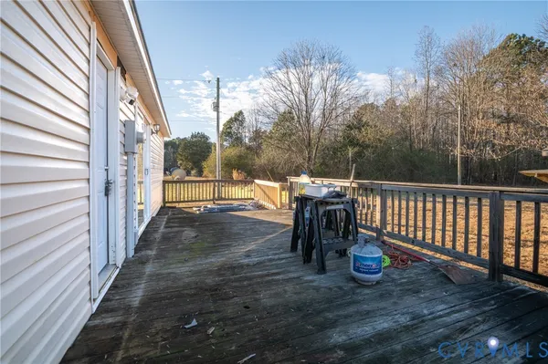 a view of a patio with a table chairs and a floor to ceiling window