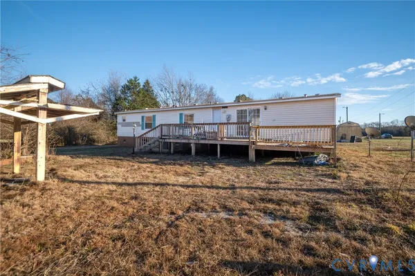 a view of a house with a yard and sitting area