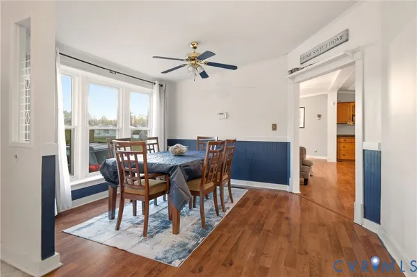 a view of a dining room with furniture and wooden floor