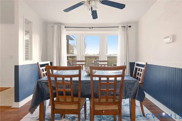 a view of a dining room with furniture and wooden floor