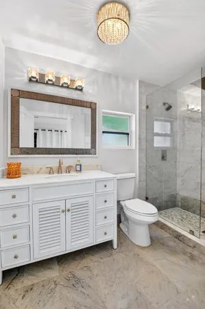 a bathroom with a double vanity sink a toilet and a mirror