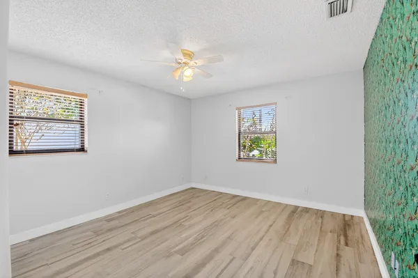 a view of room with window and wooden floor
