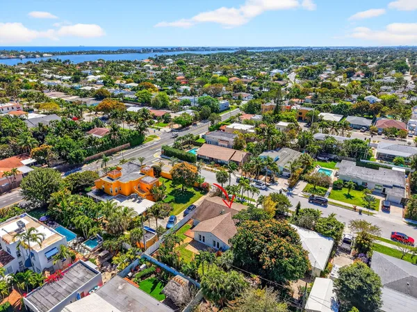an aerial view of residential houses with outdoor space and trees
