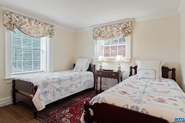 a bedroom with two beds and a window