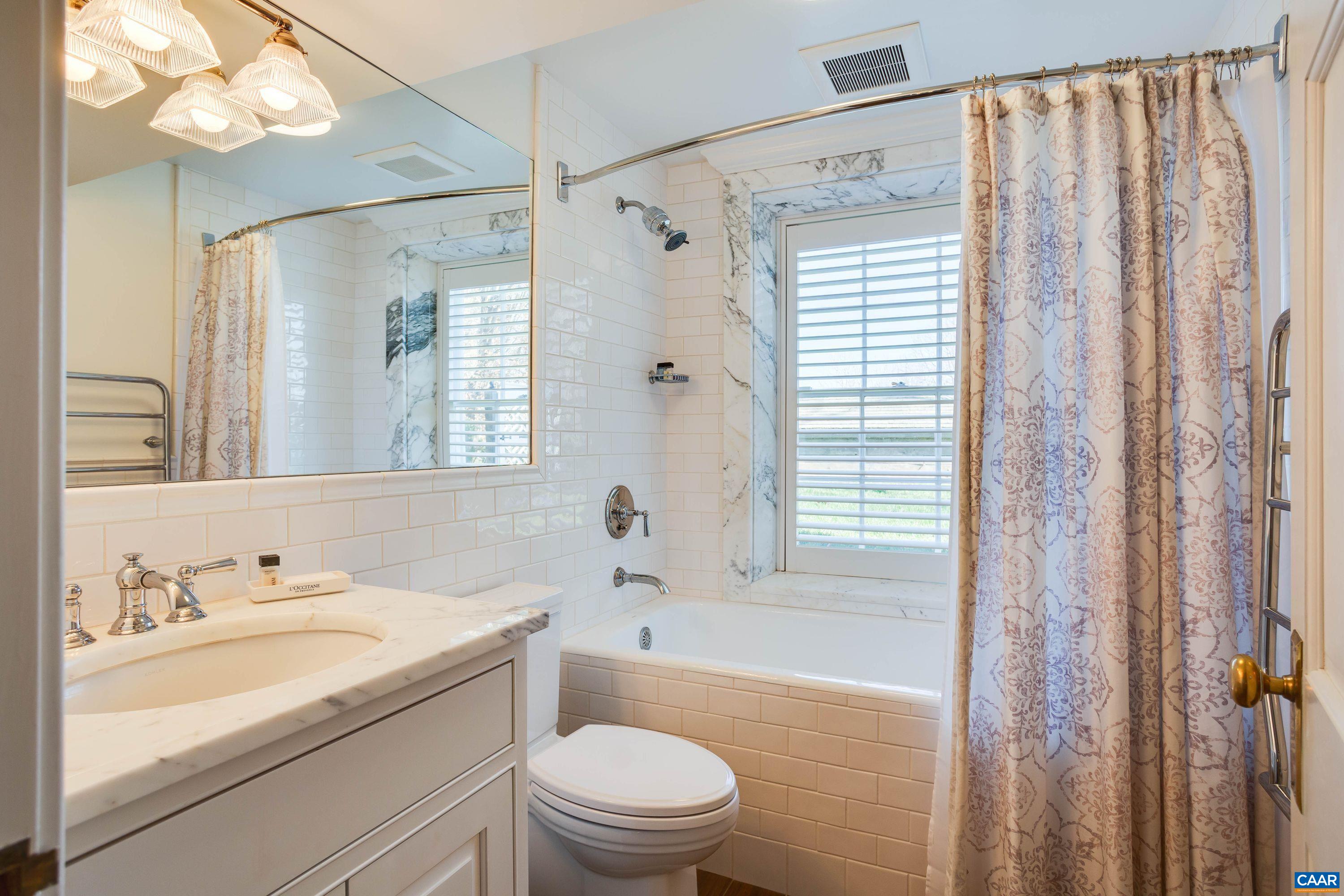 1790 Lambs Road Charlottesville, VA 22901 - Photo 26 of 53 a bathroom with a granite countertop sink a toilet and shower