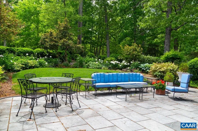 a view of backyard with furniture and outdoor seating
