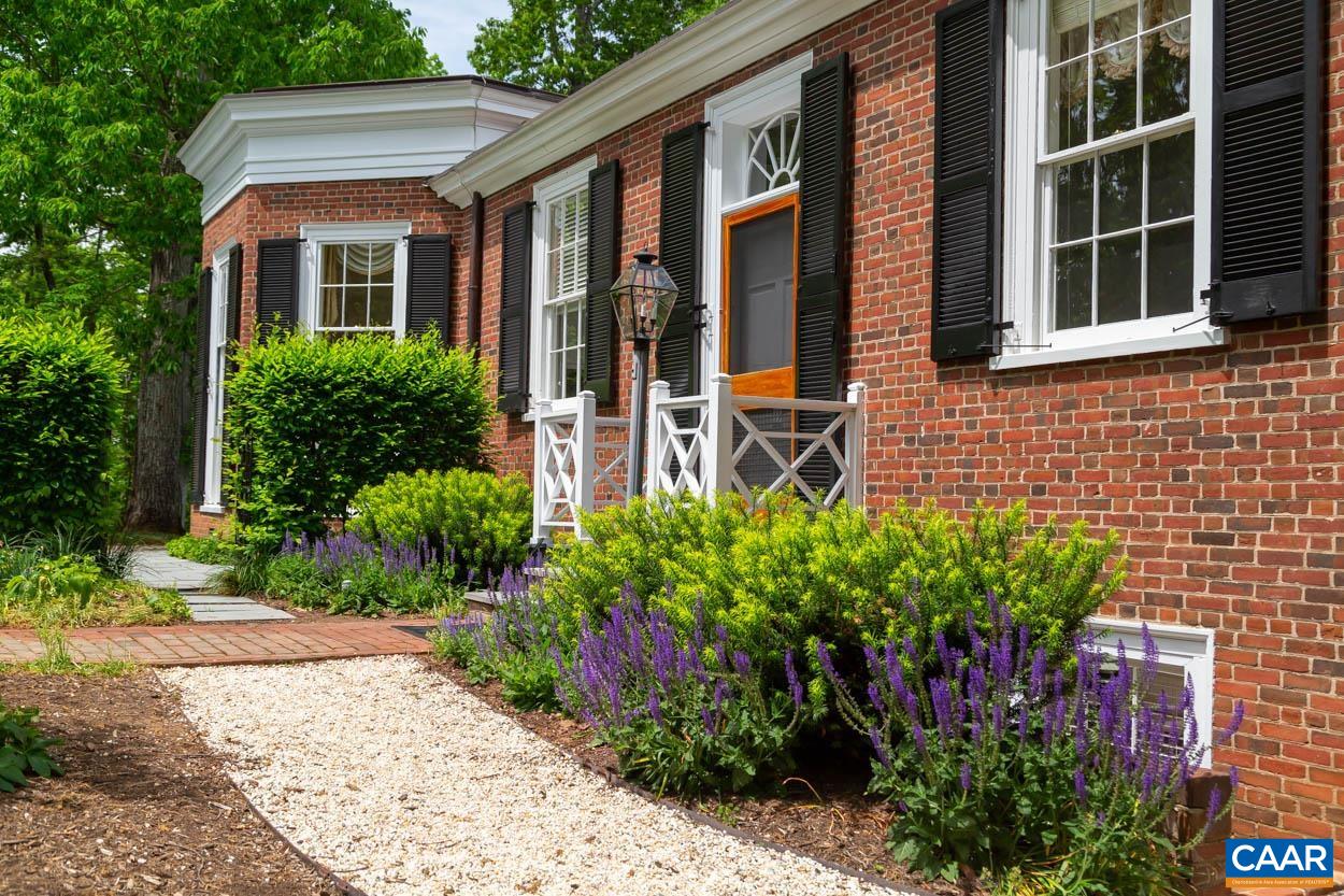 1790 Lambs Road Charlottesville, VA 22901 - Photo 29 of 53 a view of a brick house with a flower garden