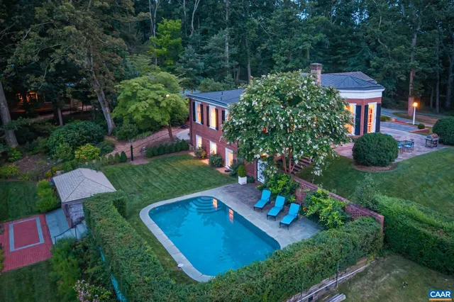 an aerial view of a house with pool a yard and outdoor seating