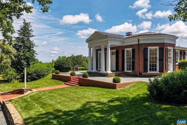 a view of a house with backyard porch and sitting area