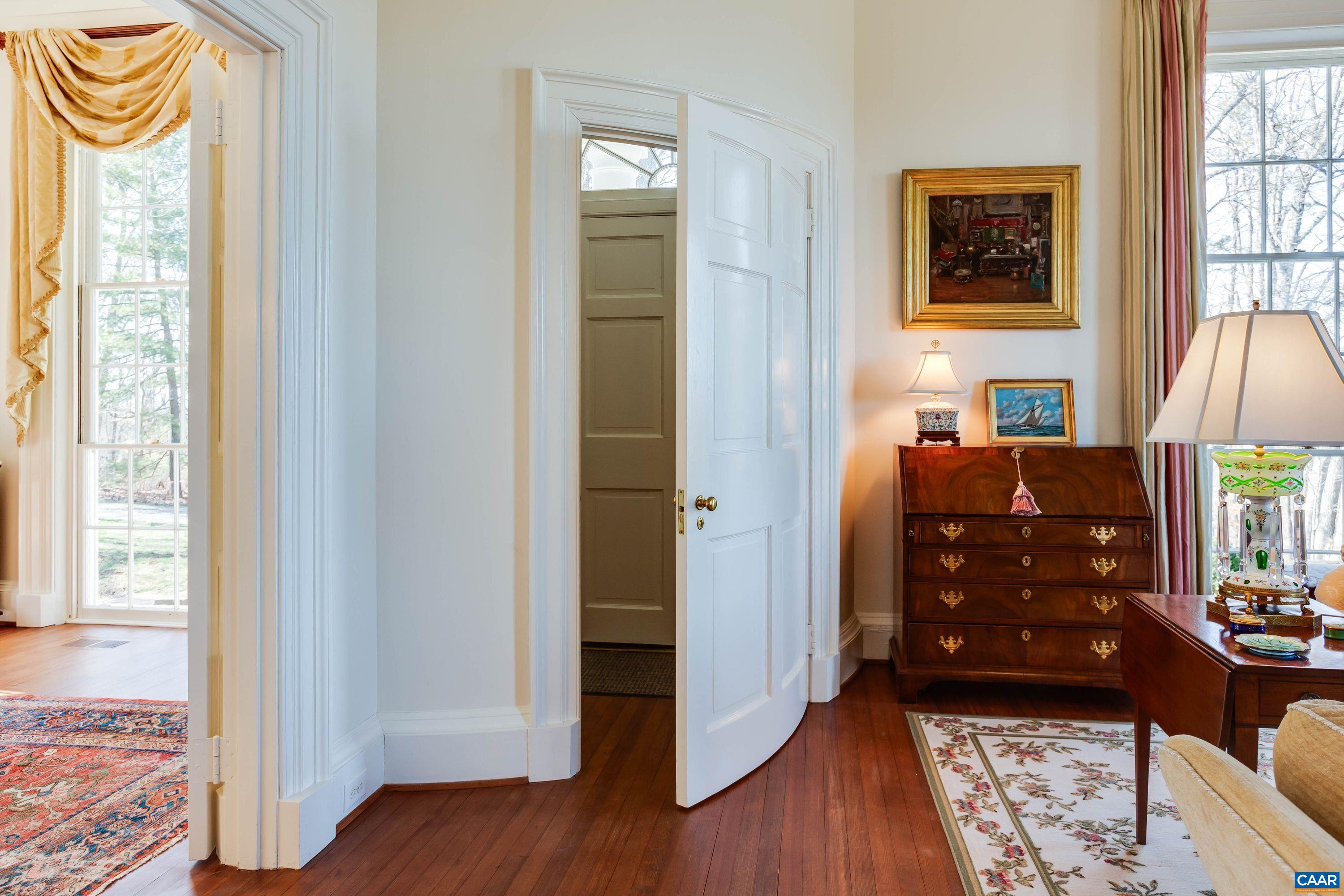 1790 Lambs Road Charlottesville, VA 22901 - Photo 5 of 53 a view of a hallway with wooden floor and a fireplace