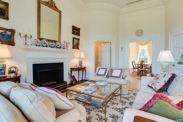 a living room with furniture fireplace and window
