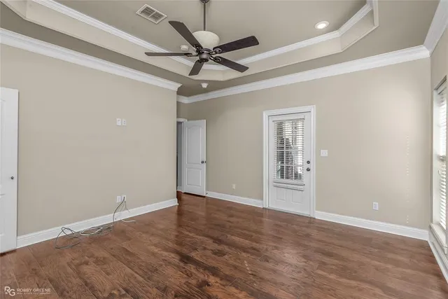 a view of an empty room with a ceiling fan