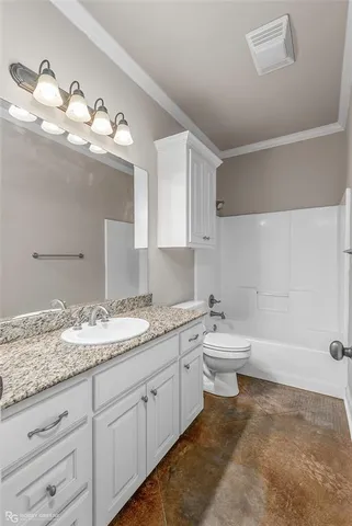 a bathroom with a granite countertop sink a toilet and a mirror