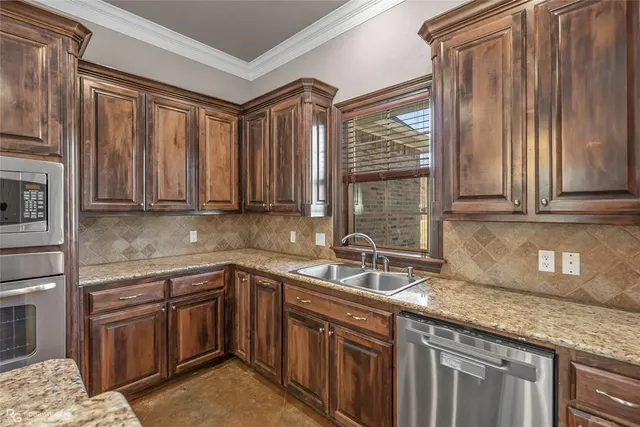a kitchen with stainless steel appliances granite countertop a sink stove and cabinets