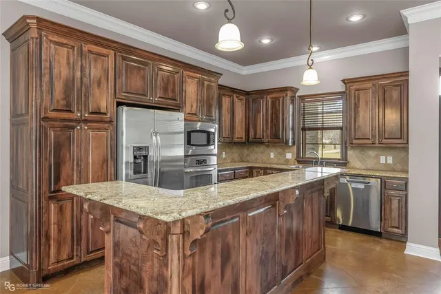 a kitchen with stainless steel appliances granite countertop a sink stove and refrigerator