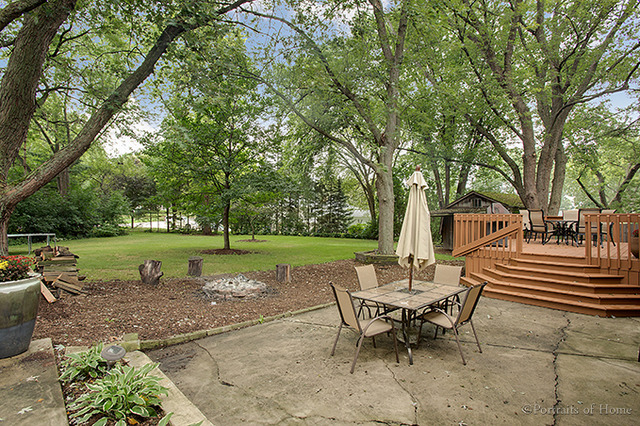 612 Ranch Road Wheaton, IL 60187 - Photo 22 of 24 a view of a patio with table and chairs with a yard