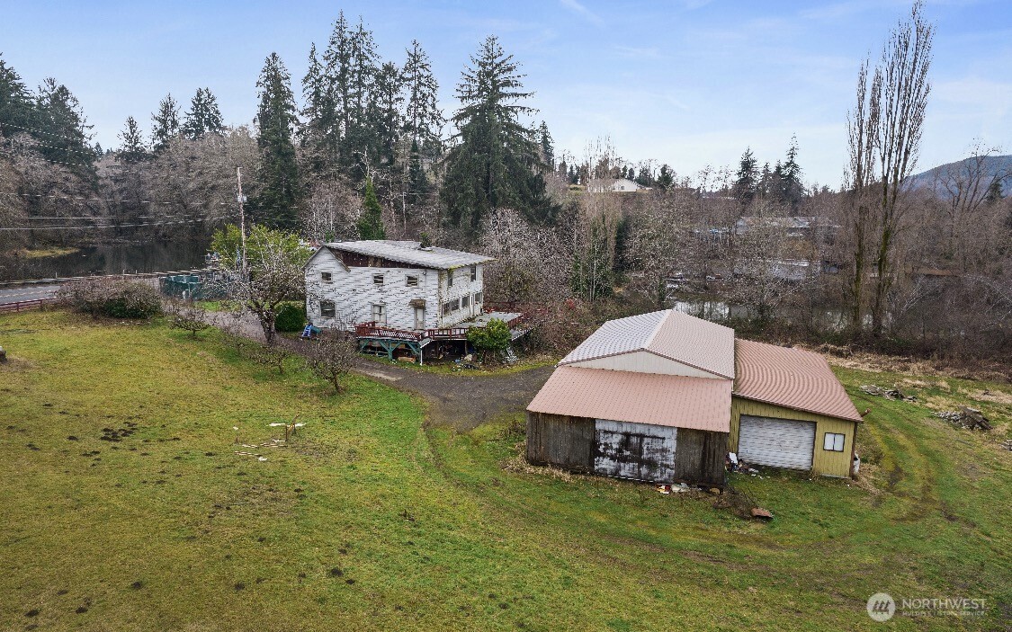 1632 Henkle Street Raymond, WA 98577 - Photo 5 of 12 an aerial view of a house with swimming pool garden view and trees