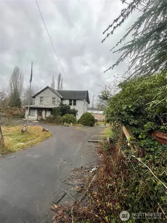 a view of a swimming pool with a yard and plants