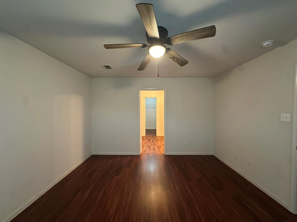 1818 Clegg Street Howe, TX 75459 - Photo 15 of 34 Spacious room featuring rich wood-finish flooring, a ceiling fan with integrated lighting, and neutral wall tones