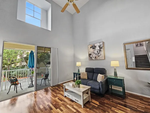 a living room with furniture and a floor to ceiling window