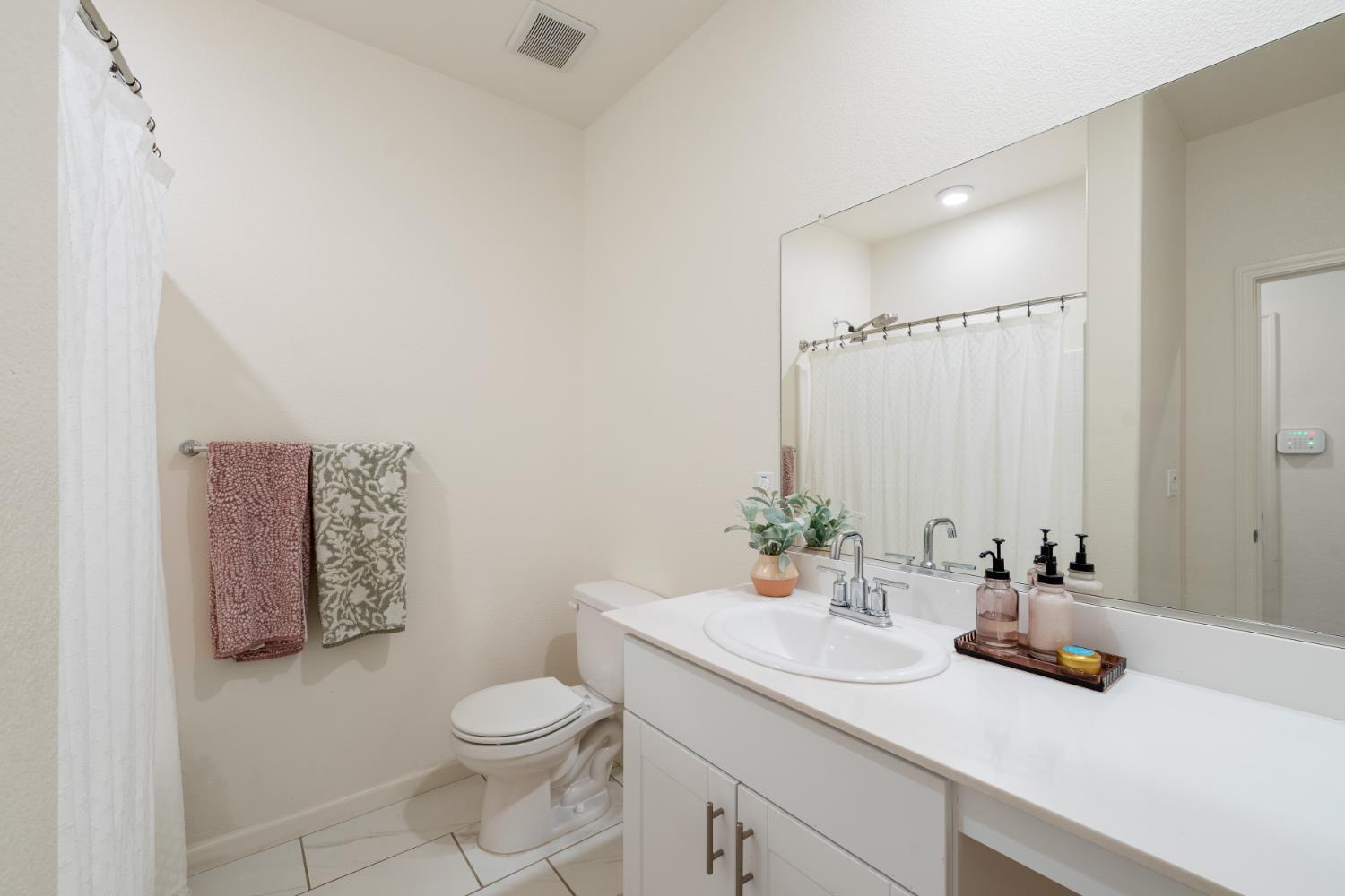 7457 Sobon Lane Rancho Murieta, CA 95683 - Photo 20 of 32 a bathroom with a sink a toilet and mirror