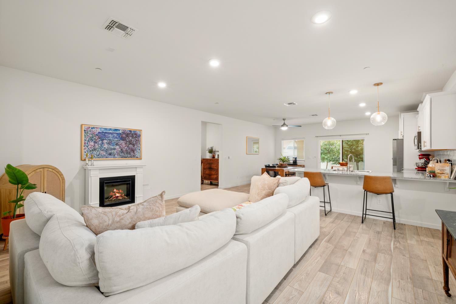 7457 Sobon Lane Rancho Murieta, CA 95683 - Photo 2 of 32 a living room with furniture a fireplace and a flat screen tv