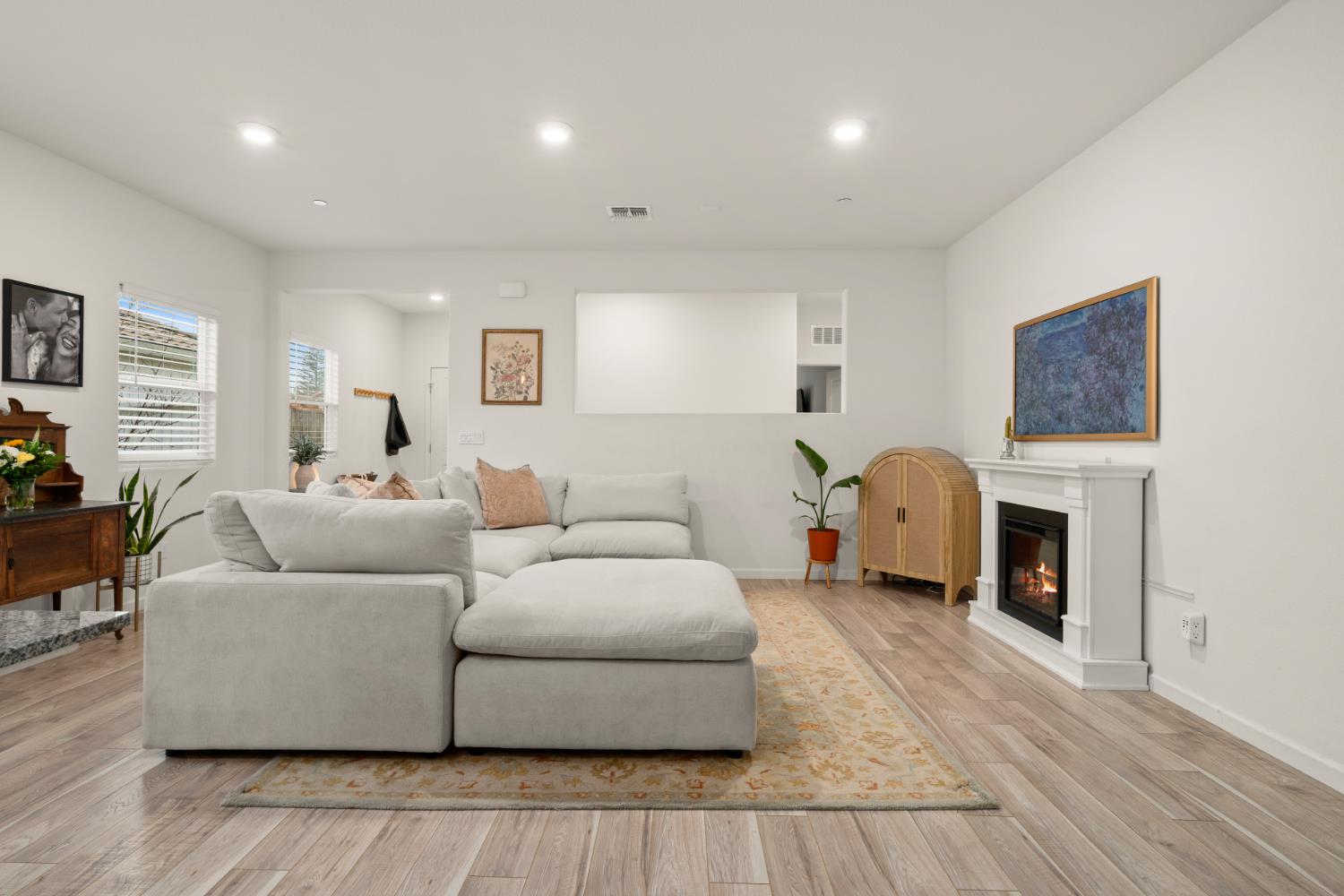 7457 Sobon Lane Rancho Murieta, CA 95683 - Photo 6 of 32 a living room with furniture a fireplace and a flat screen tv