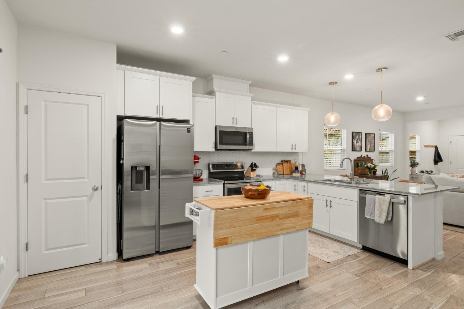 7457 Sobon Lane Rancho Murieta, CA 95683 - Photo 8 of 32 a kitchen with stainless steel appliances a stove a sink a refrigerator a microwave a sink and cabinets