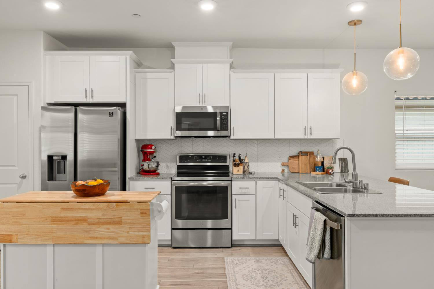 7457 Sobon Lane Rancho Murieta, CA 95683 - Photo 9 of 32 a kitchen with stainless steel appliances granite countertop a sink stove and refrigerator