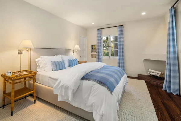 a bedroom with a bed and a night stand