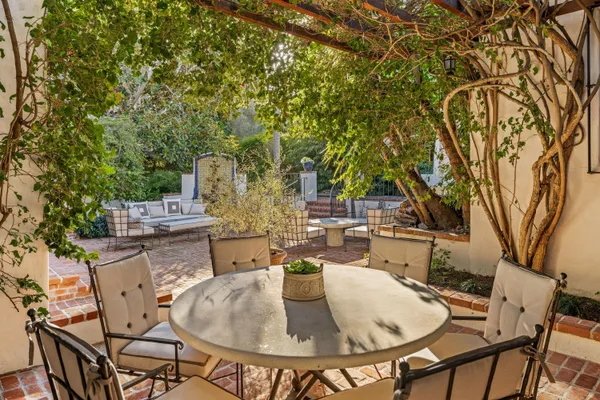 a backyard of a house with table and chairs