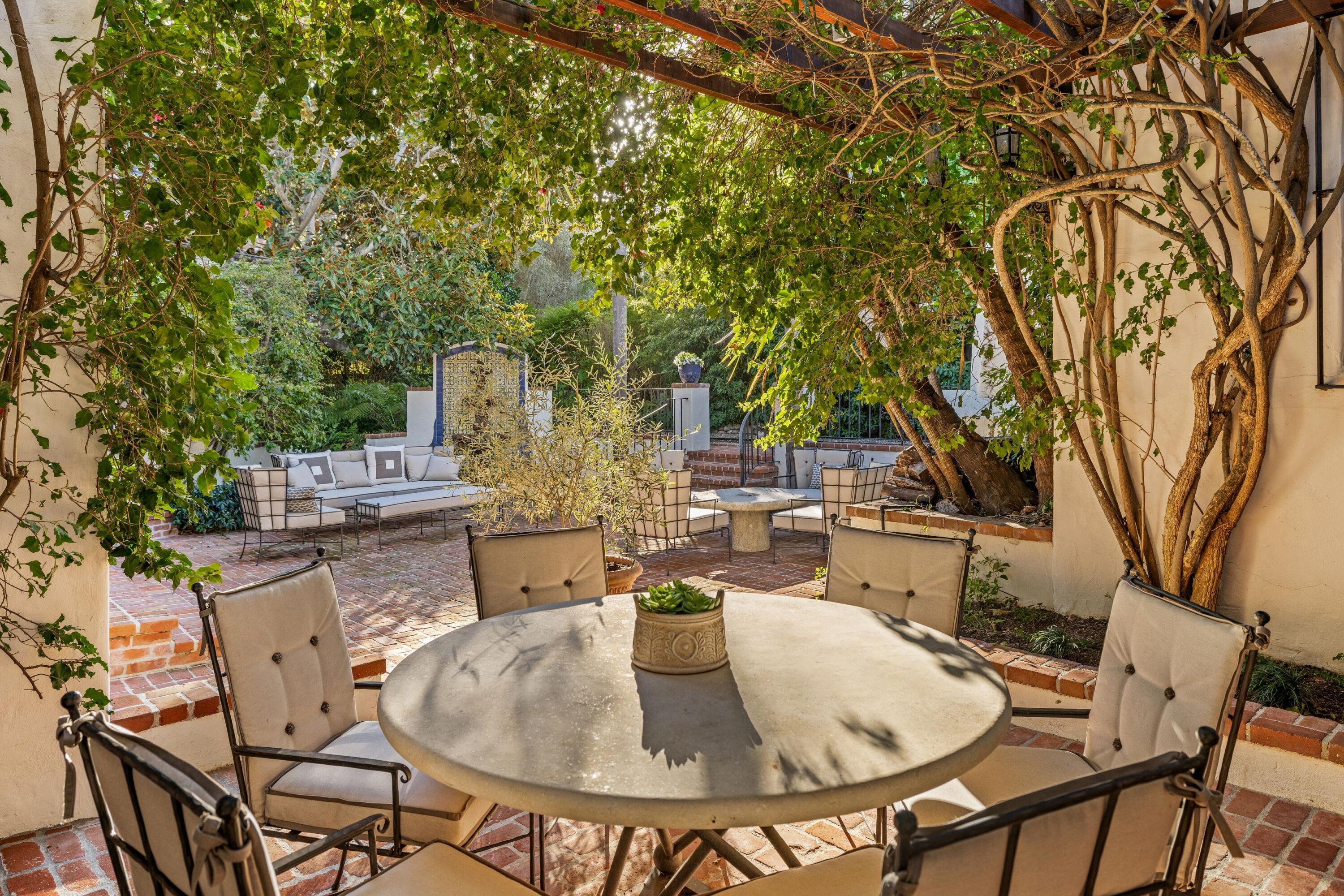 1284 Mesa Road Montecito, CA 93108 - Photo 23 of 26 a backyard of a house with table and chairs