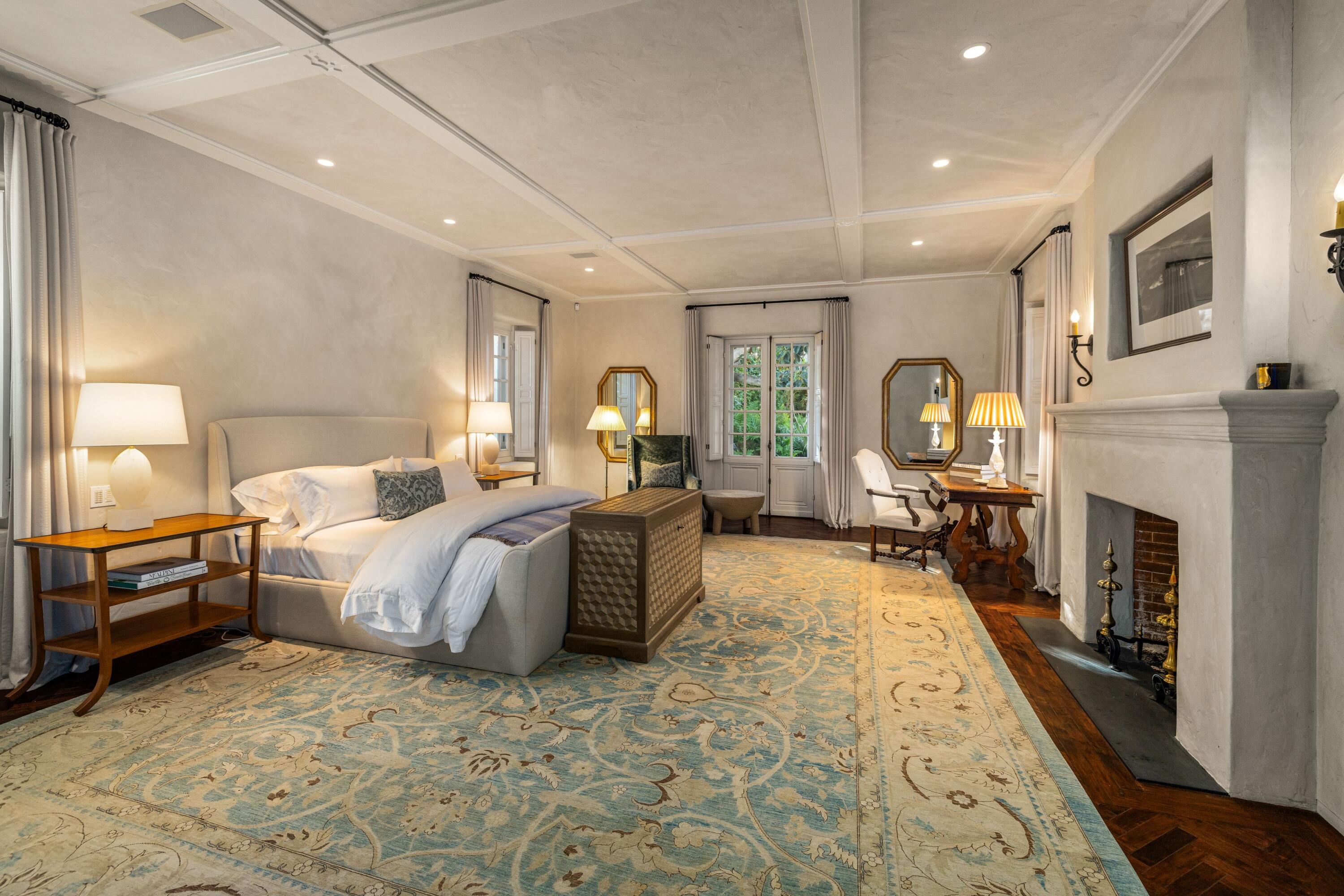 1284 Mesa Road Montecito, CA 93108 - Photo 6 of 26 a bed room with a bed couches and a fireplace