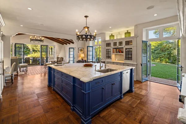 a large kitchen with kitchen island a large island in the center and stainless steel appliances