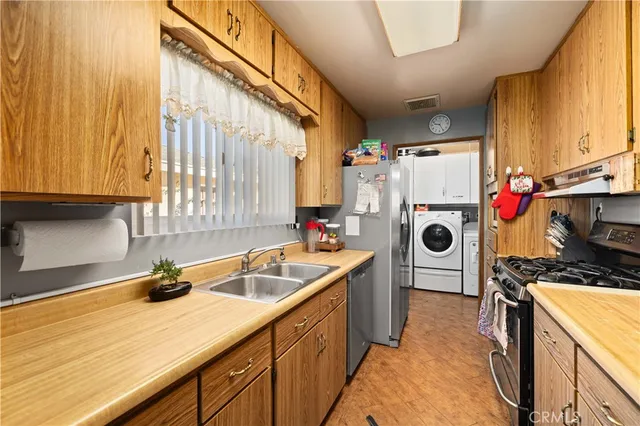 a kitchen with a sink and a stove top oven