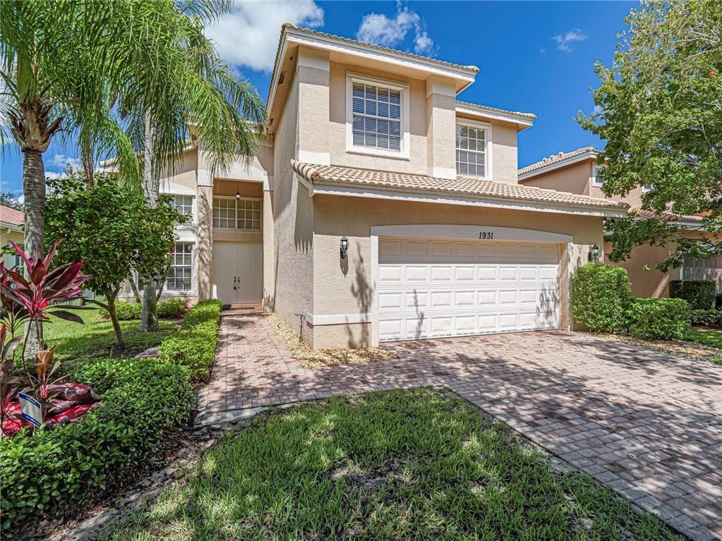 1931 Grey Falcon Circle Southwest Vero Beach, FL 32962 - Photo 1 of 36 a view of a house with a yard and potted plants