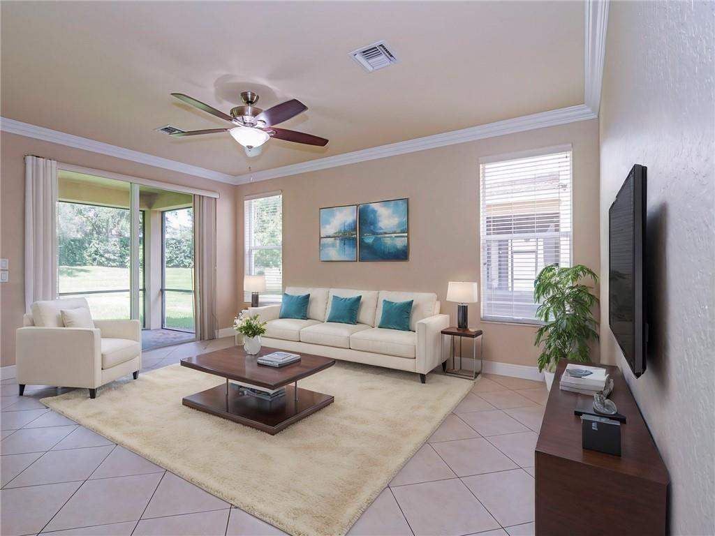 1931 Grey Falcon Circle Southwest Vero Beach, FL 32962 - Photo 11 of 36 a living room with furniture potted plant and a large window