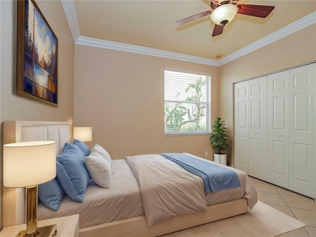 1931 Grey Falcon Circle Southwest Vero Beach, FL 32962 - Photo 12 of 36 a bedroom with a bed and a painting on the wall